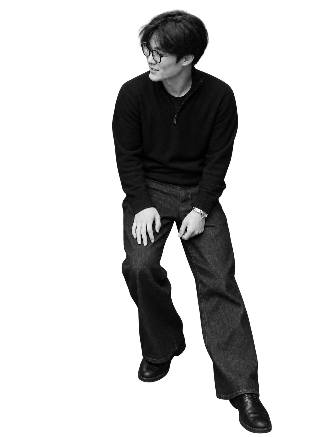 Jin Kim seated in glasses and a black sweater.
